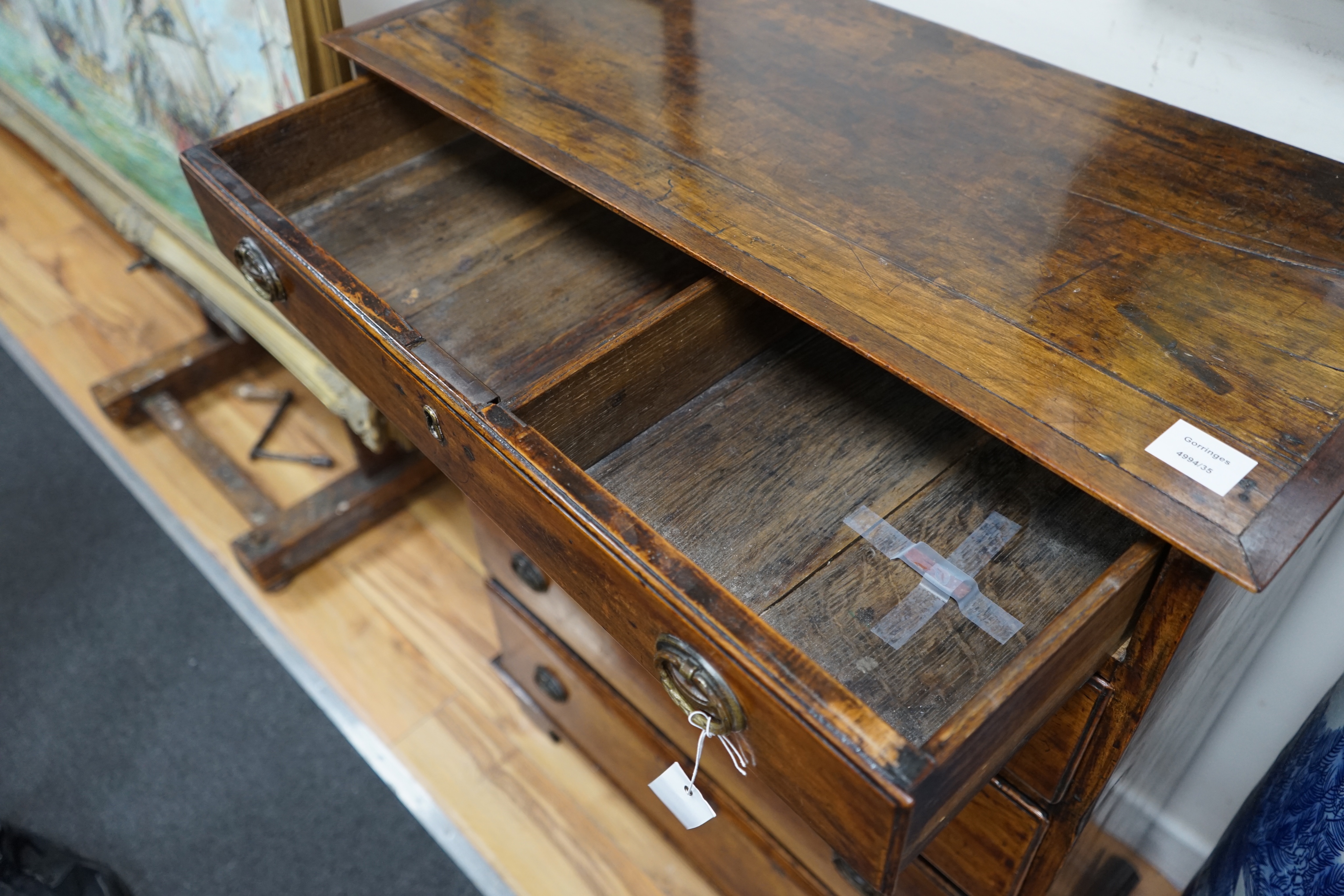 A George III fruitwood chest of five graduating long drawers, width 79cm depth 36cm height 102cm